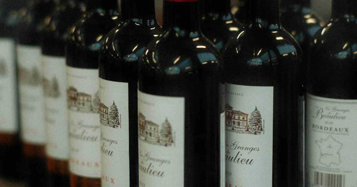 A row of Bordeaux bottles carrying classic illustrated chateau labels